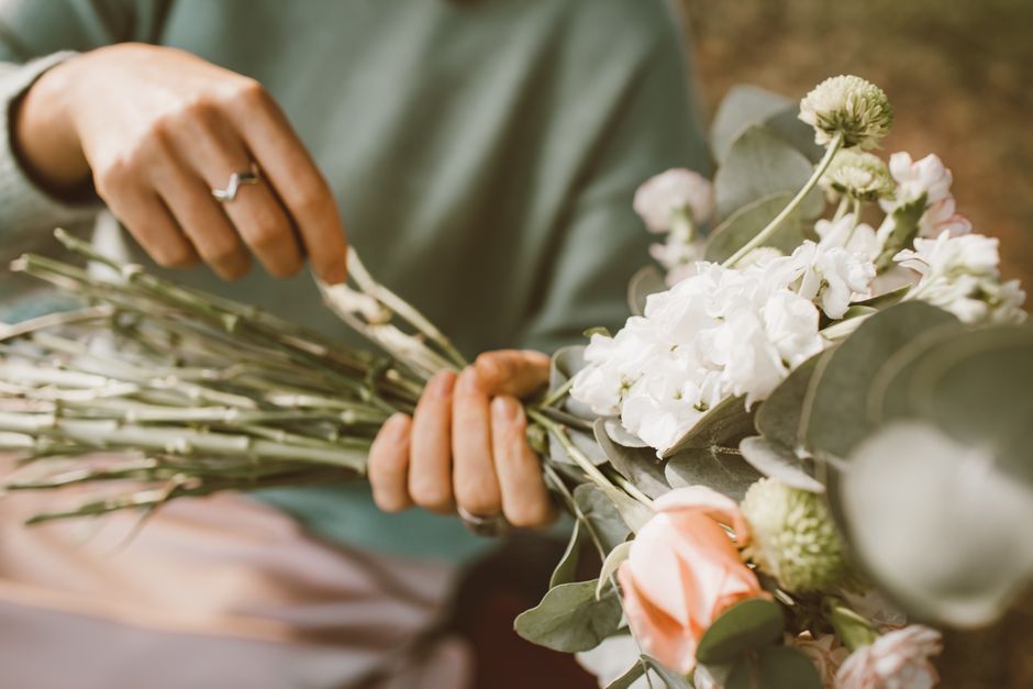 Florist arranging beautiful wedding flowers